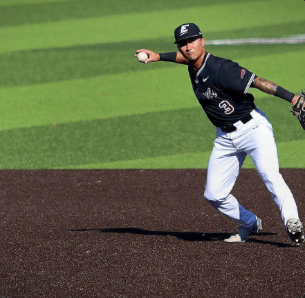 Baseball player fielding a ground ball at golden hour